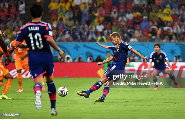 Keisuke Honda of Japan scores the opening goal during the 2014 FIFA World Cup Brazil Group C match between Cote D'Ivoire and Japan at Arena...