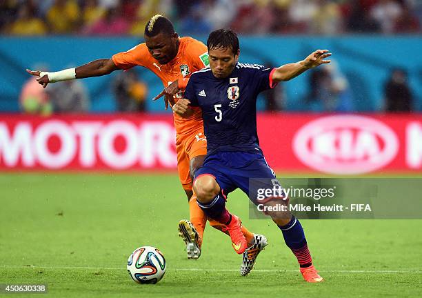 Yuto Nagatomo of Japan is challenged by Die Serey of the Ivory Coast during the 2014 FIFA World Cup Brazil Group C match between Cote D'Ivoire and...