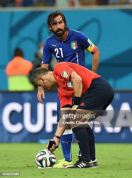 Referee Bjorn Kuipers sprays a temporary line as Andrea Pirlo of Italy prepares to take on a free kick during the 2014 FIFA World Cup Brazil Group D...