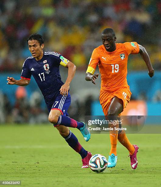 Yaya Toure of the Ivory Coast controls the ball against Makoto Hasebe of Japan during the 2014 FIFA World Cup Brazil Group C match between the Ivory...