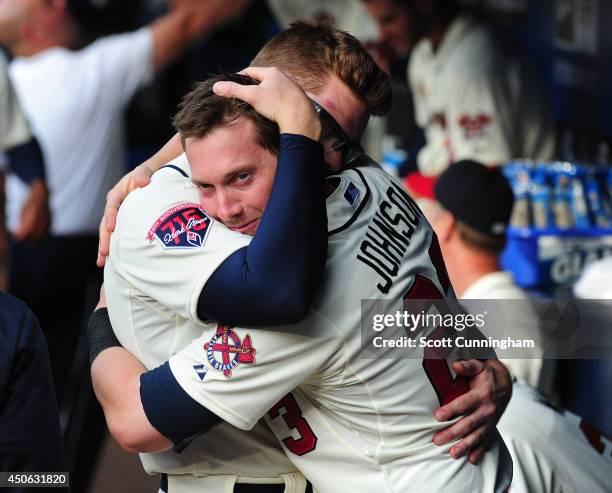 Chris Johnson and Freddie Freeman of the Atlanta Braves embrace before the game against the Los Angeles Angels of Anaheim at Turner Field on June 14,...