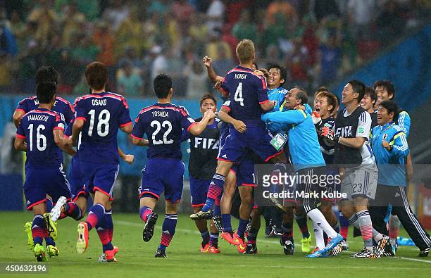 Japan celebrate their first goal scored by Keisuke Honda during the 2014 FIFA World Cup Brazil Group C match between the Ivory Coast and Japan at...