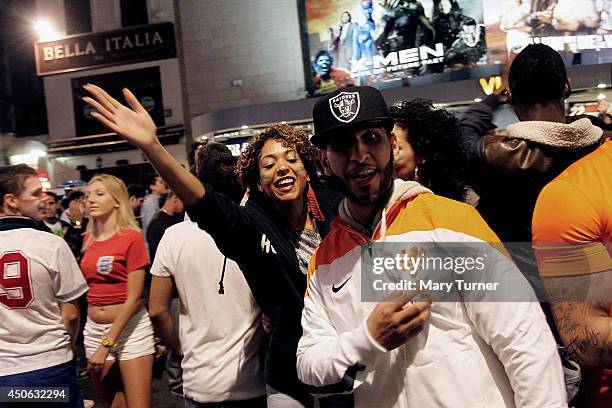 Italian football fans celebrate in Leicester Square after their team beat England 2-1 in their opening game of the 2014 FIFA World Cup on June 14,...