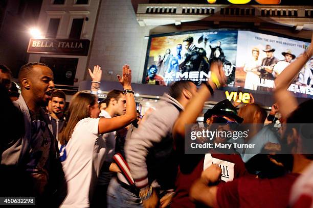 Italian football fans celebrate in Leicester Square after Italy beat England 2-1 in their opening game of the 2014 FIFA World Cup on June 14, 2014 in...