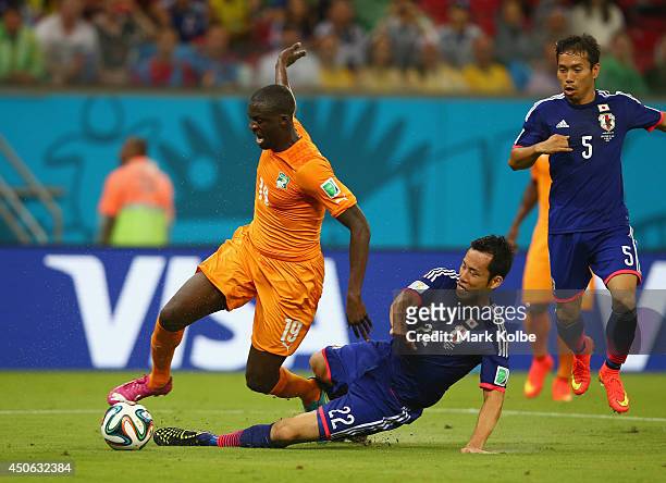 Maya Yoshida of Japan tackles Yaya Toure of the Ivory Coast during the 2014 FIFA World Cup Brazil Group C match between the Ivory Coast and Japan at...