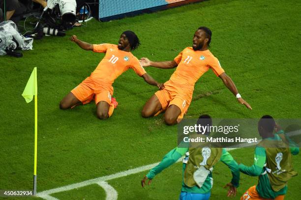 Gervinho of the Ivory Coast celebrates scoring his team's second goal with teammate Didier Drogba during the 2014 FIFA World Cup Brazil Group C match...