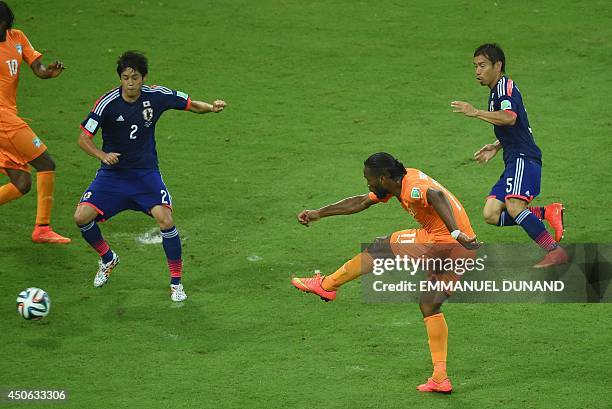 Ivory Coast's forward and captain Didier Drogba has a shot on goal during a Group C football match between Ivory Coast and Japan at the Pernambuco...