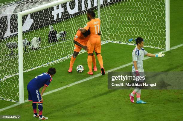 Wilfried Bony of the Ivory Coast celebrates scoring his team's first goal with Didier Drogba of the Ivory Coast as goalkeeper Eiji Kawashima of Japan...