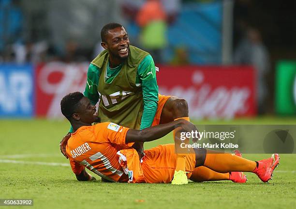 Serge Aurier of the Ivory Coast and Jean-Daniel Akpa-Akpro of the Ivory Coast hug after defeating Japan 2-1 during the 2014 FIFA World Cup Brazil...