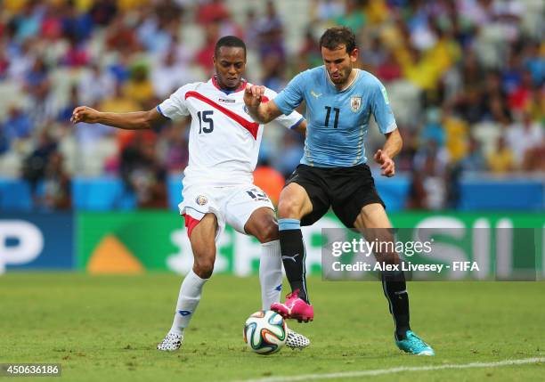 Junior Diaz of Costa Rica in action with Christian Stuani of Uruguay during the 2014 FIFA World Cup Brazil Group D match between Uruguay and Costa...