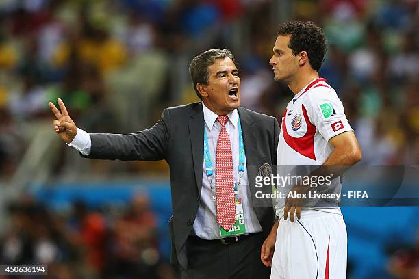 Jorge Luis Pinto of Costa Rica talks with Marco Urena of Costa Rica during the 2014 FIFA World Cup Brazil Group D match between Uruguay and Costa...