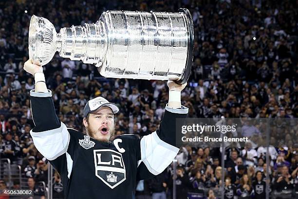 Dustin Brown of the Los Angeles Kings celebrates with the Stanley Cup after the Kings 3-2 double overtime victory against the New York Rangers in...