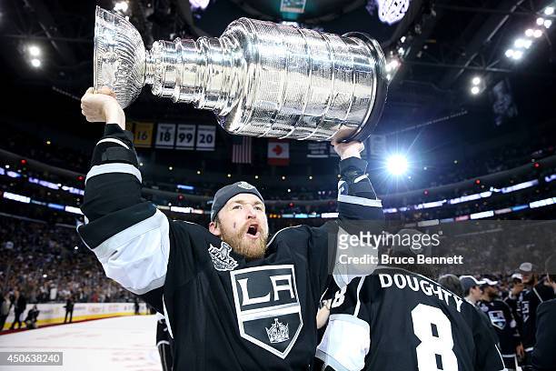 Trevor Lewis of the Los Angeles Kings celebrates with the Stanley Cup after the Kings 3-2 double overtime victory against the New York Rangers in...