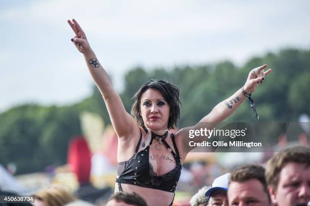 Girl in the crowd on her friends shoulders watches on as Bring Me The Horizon performs on stage at Download Festival at Donnington Park on June 14,...