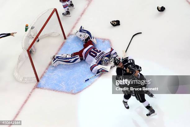 Alec Martinez of the Los Angeles Kings celebrates with Kyle Clifford after Martinez scores the game-winning goal in double overtime against...