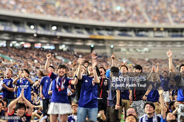 Japanese fans cheer on their team during the 2014 FIFA World Cup match between Japan and Cote d'Ivoire during the public viewing event at Tokyo Dome...