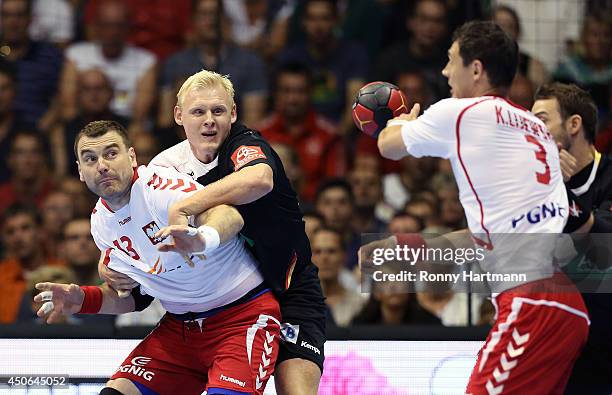 Patrick Wiencek of Germany copmetes with Bartosz Jurecki and Krzysztof Lijewski of Poland during the IHF World Championship 2015 Playoff Leg Two...