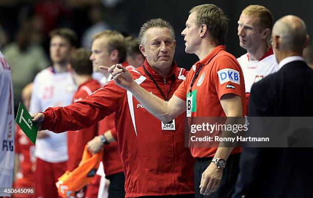 Head coach Michael Biegler of Poland argues with head coach Martin Heuberger of Germany during the IHF World Championship 2015 Playoff Leg Two...