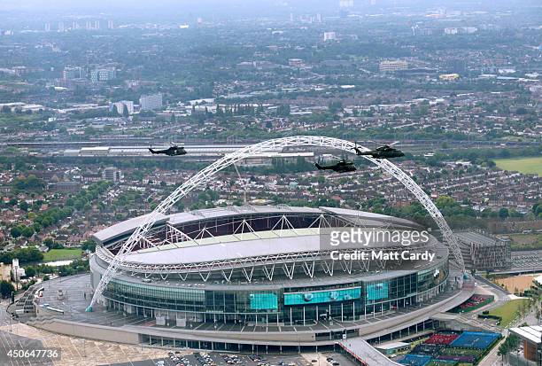 Helicopters pass Wembley Stadium seen from the air on June 14, 2014 in London, England.