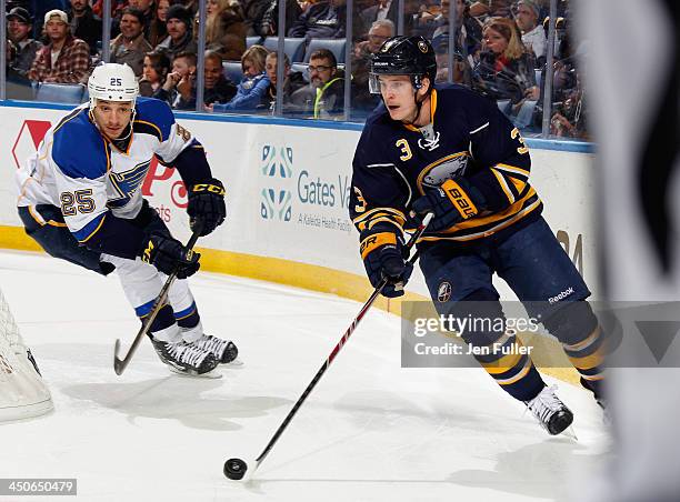 Mark Pysyk of the Buffalo Sabres carries the puck against Chris Stewart of the St. Louis Blues at First Niagara Center on November 19, 2013 in...