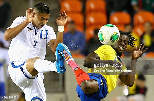 Emilio Izaguirre of Honduras jumps for the ball against Juan Carlos Paredes of Ecuador during an international friendly match at BBVA Compass Stadium...