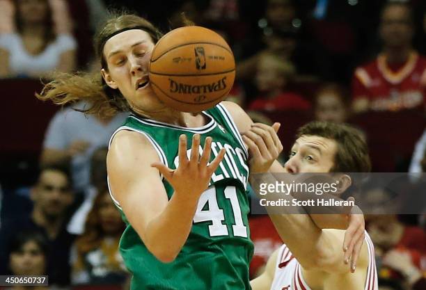 Kelly Olynyk of the Boston Celtics battles for a loose ball with Omer Asik of the Houston Rockets at the Toyota Center on November 19, 2013 in...