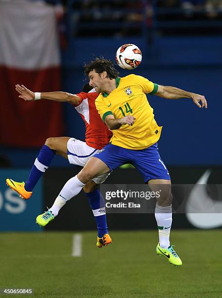 Maxwell of Brazil and Alexis Sanchez of Chile vie for the ball during a friendly match at Rogers Centre on November 19, 2013 in Toronto, Canada.