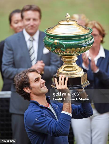 Roger Federer of Switzerland lifts the trophy after winning the final match against Alejandro Falla of Colombia of the Gerry Weber Open at Gerry...