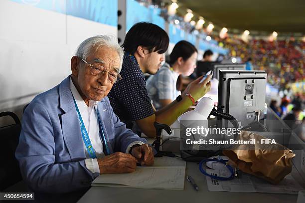 Japanese journalist Hiroshi Kagawa works during the 2014 FIFA World Cup Brazil Group C match between Cote D'Ivoire and Japan at Arena Pernambuco on...