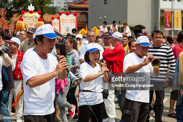 Musicians blow on a suona, a type of oboe, during a festival to mark the Bao Sheng Emperor's birthday in Taipei, Taiwan..
