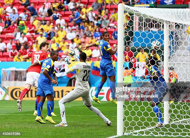 Admir Mehmedi of Switzerland scores his team's first goal on a header past goalkeeper Alexander Dominguez of Ecuador during the 2014 FIFA World Cup...