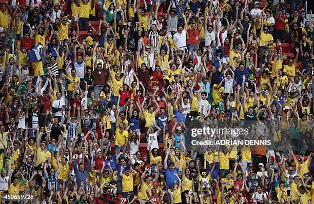 Ecuador's fans cheer during a Group E football match between Switzerland and Ecuador at the Mane Garrincha National Stadium in Brasilia during the...