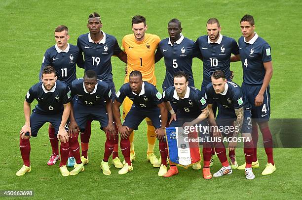 The French national team pose France's forward Antoine Griezmann, France's midfielder Paul Pogba, France's goalkeeper and captain Hugo Lloris,...