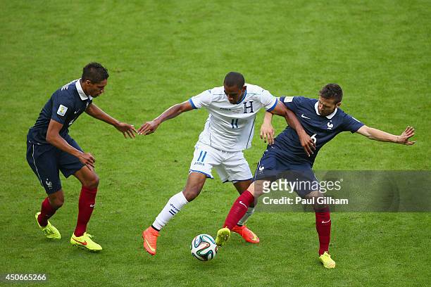 Jerry Bengtson of Honduras controls the ball against Raphael Varane and Yohan Cabaye of France during the 2014 FIFA World Cup Brazil Group E match...