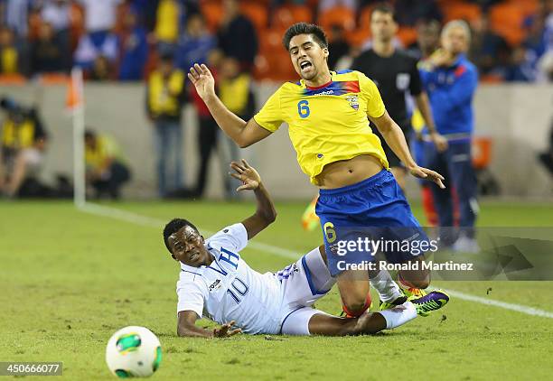 Marvin Chavez of Honduras trips up Christian Noboa of Ecuador during an international friendly match at BBVA Compass Stadium on November 19, 2013 in...