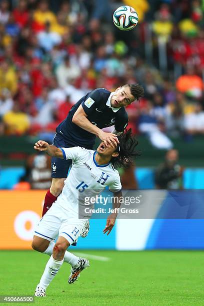 Mathieu Debuchy of France goes up for a header against Roger Espinoza of Honduras during the 2014 FIFA World Cup Brazil Group E match between France...