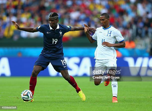 Paul Pogba of France holds off a challenge by Jerry Bengtson of Honduras during the 2014 FIFA World Cup Brazil Group E match between France and...