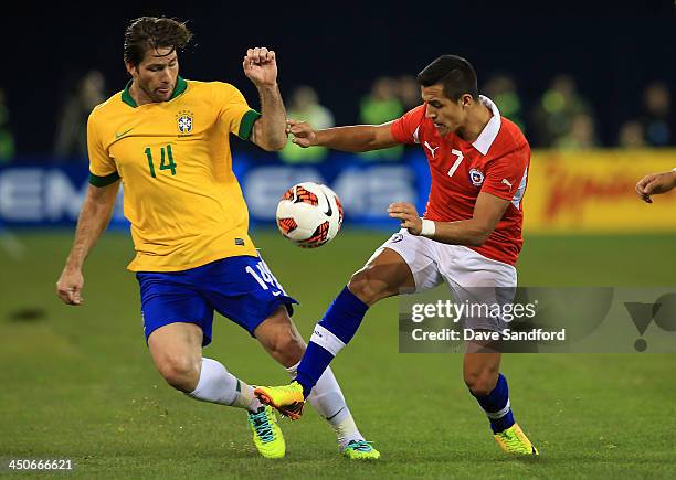 Maxwell of Brazil battles for the ball with Alexis Sanchez of Chile during a friendly match at Rogers Centre on November 19, 2013 in Toronto, Canada.