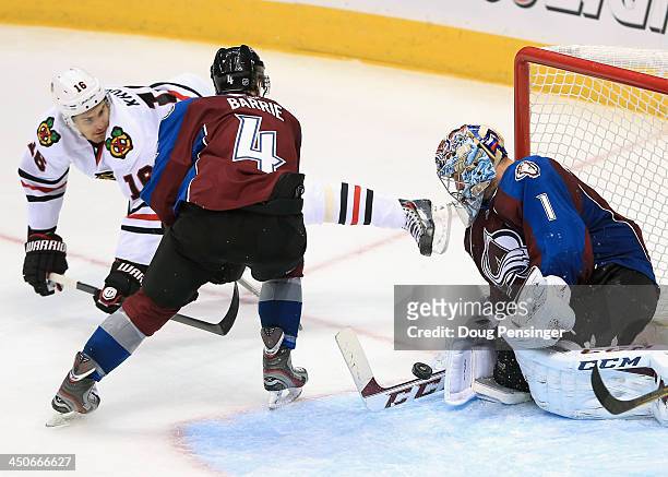 Goalie Semyon Varlamov of the Colorado Avalanche makes a save on a shot by Marcus Kruger of the Chicago Blackhawks as Tyson Barrie of the Colorado...