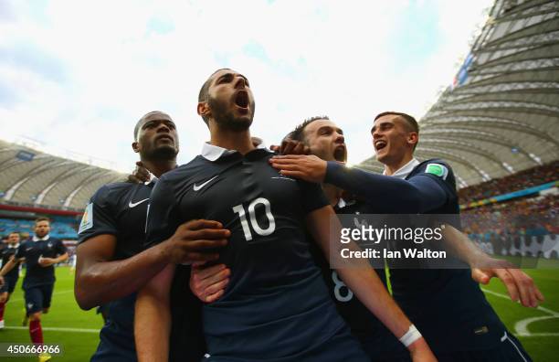 Karim Benzema of France celebrates with teammates after scoring his team's first goal on a penalty kick during the 2014 FIFA World Cup Brazil Group E...