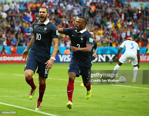Karim Benzema of France celebrates scoring his team's first goal on a penalty kick with Patrice Evra during the 2014 FIFA World Cup Brazil Group E...