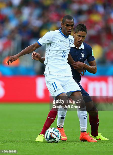 Jerry Bengtson of Honduras fights off Raphael Varane of France during the 2014 FIFA World Cup Brazil Group E match between France and Honduras at...
