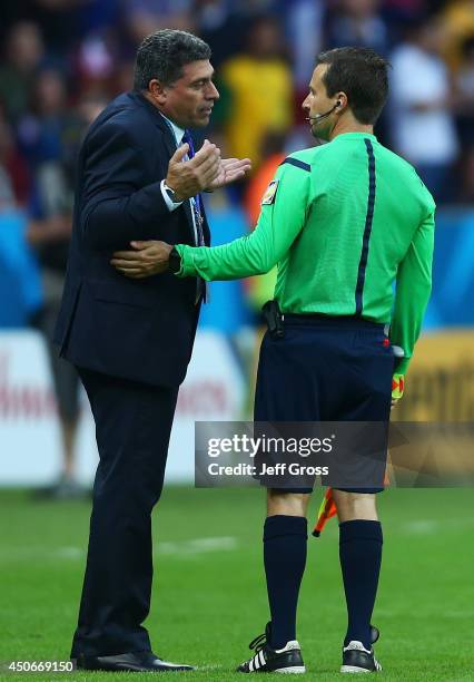 Luis Fernando Suarez of Honduras in discussion with assistant referee after France's second goal during the 2014 FIFA World Cup Brazil Group E match...