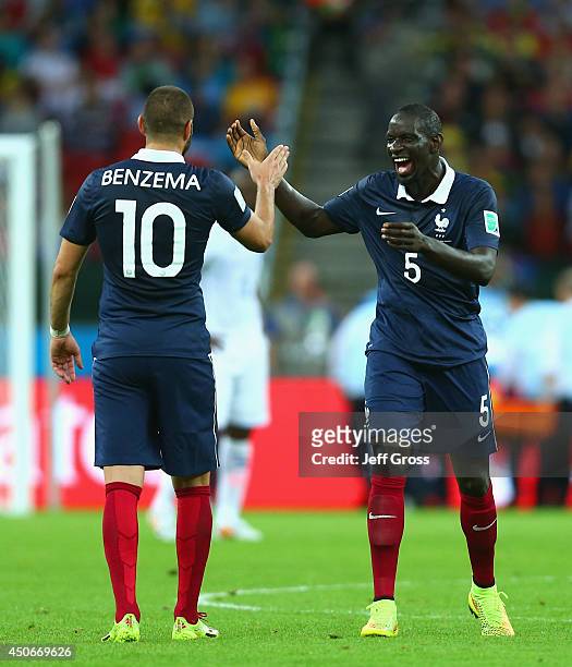 Karim Benzema of France celebrates scoring his team's third goal with teammate Mamadou Sakho during the 2014 FIFA World Cup Brazil Group E match...