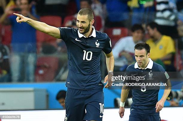 France's forward Karim Benzema celebrates after scoring his teams third goal followed by midfielder Mathieu Valbuena, during a Group E football match...