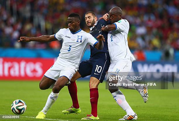 Karim Benzema of France is caught between Maynor Figueroa of Honduras and Osman Chavez of Honduras during the 2014 FIFA World Cup Brazil Group E...