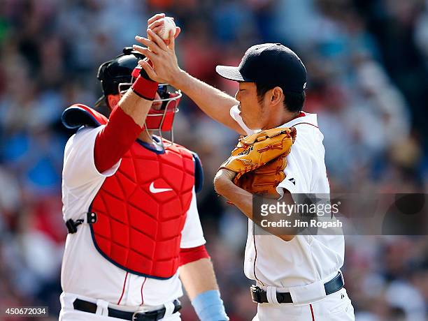 Koji Uehara of the Boston Red Sox celebrates his scoreless ninth inning with A.J. Pierzynski against the Cleveland Indians at Fenway Park on June 15,...