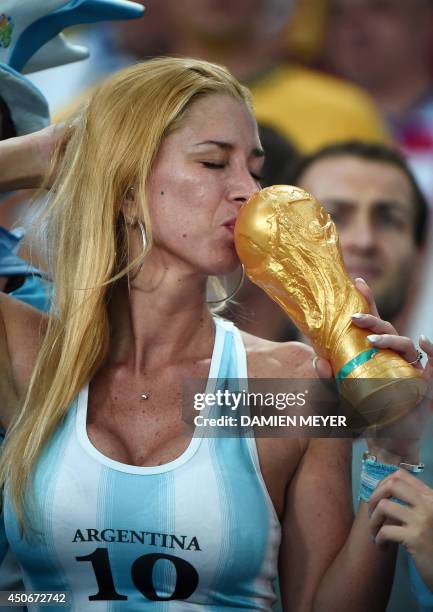 Argentina's fan kisses a fake trophy before for the Group F football match between Argentina and Bosnia-Hercegovina at the Maracana Stadium in Rio De...