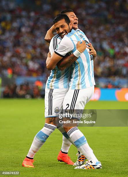 Marcos Rojo and Ezequiel Garay of Argentina celebrate their team's first goal during the 2014 FIFA World Cup Brazil Group F match between Argentina...