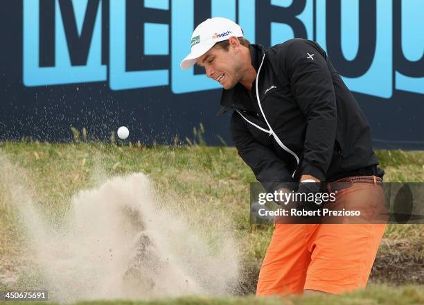 Tom Hawkins Geelong Cats AFL footballer plays out of the bunker on the 10th hole during the Pro-Am ahead of the World Cup of Golf at Royal Melbourne...